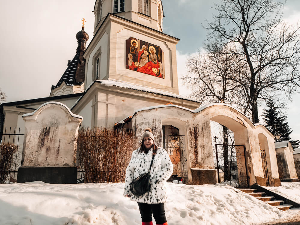 Woman standing in the snow at Trakai in Lithuania