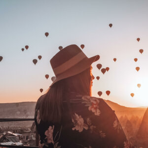 Watching the hot air balloons at Goreme Cappadocia, Turkey the ultimate bucket list place. Read moe on the blog www.ouruniquestays.com