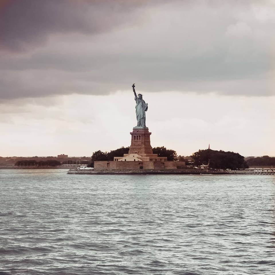 The statue of liberty as seen from the Staten Island Ferry. Read more on www.ouruniquestays.com