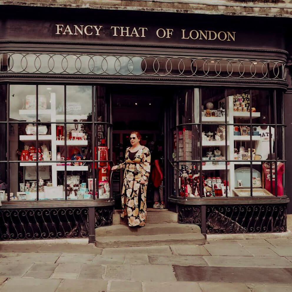 Woman in a floral dress shopping in Bath city UK, one of the reasons to visit Bath