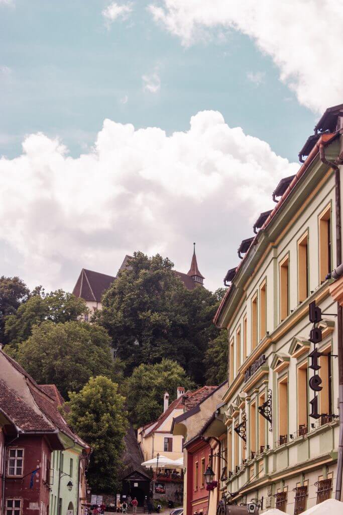The colourful streets of Medieval Sighisoara in Transylvania Romania.