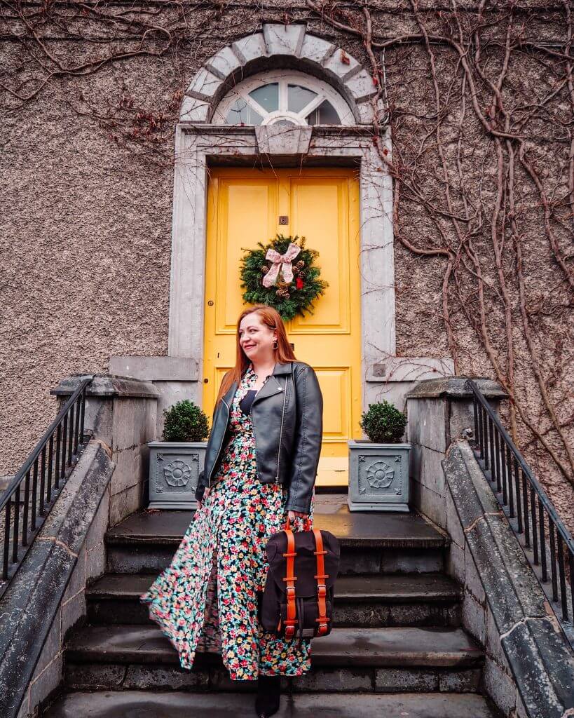 Girl standing in front of a yellow door