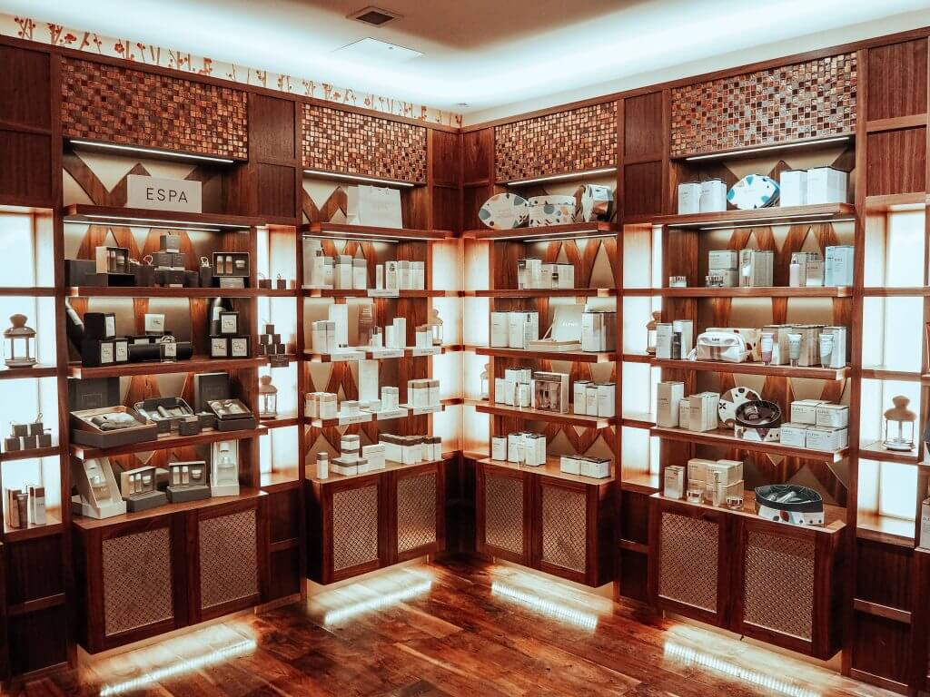 Waiting area of the Thai Spa at Lough Erne. Shelved area contain Spa products and ESPA toiletries.