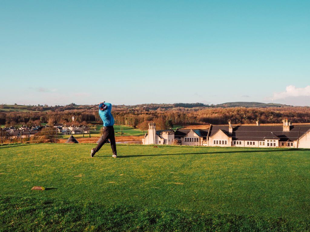 Man hitting a golf ball in Lough Erne Resort in Northern Ireland