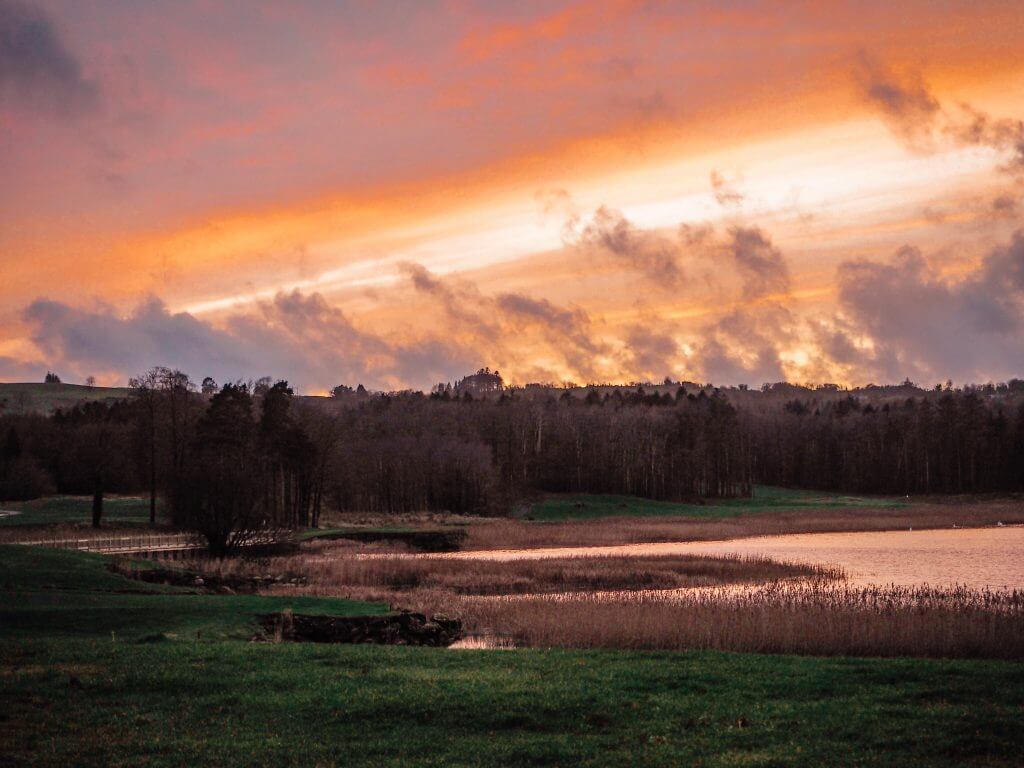 Beautiful pink and gold sunset over Castle Hume Lough in Northern Ireland