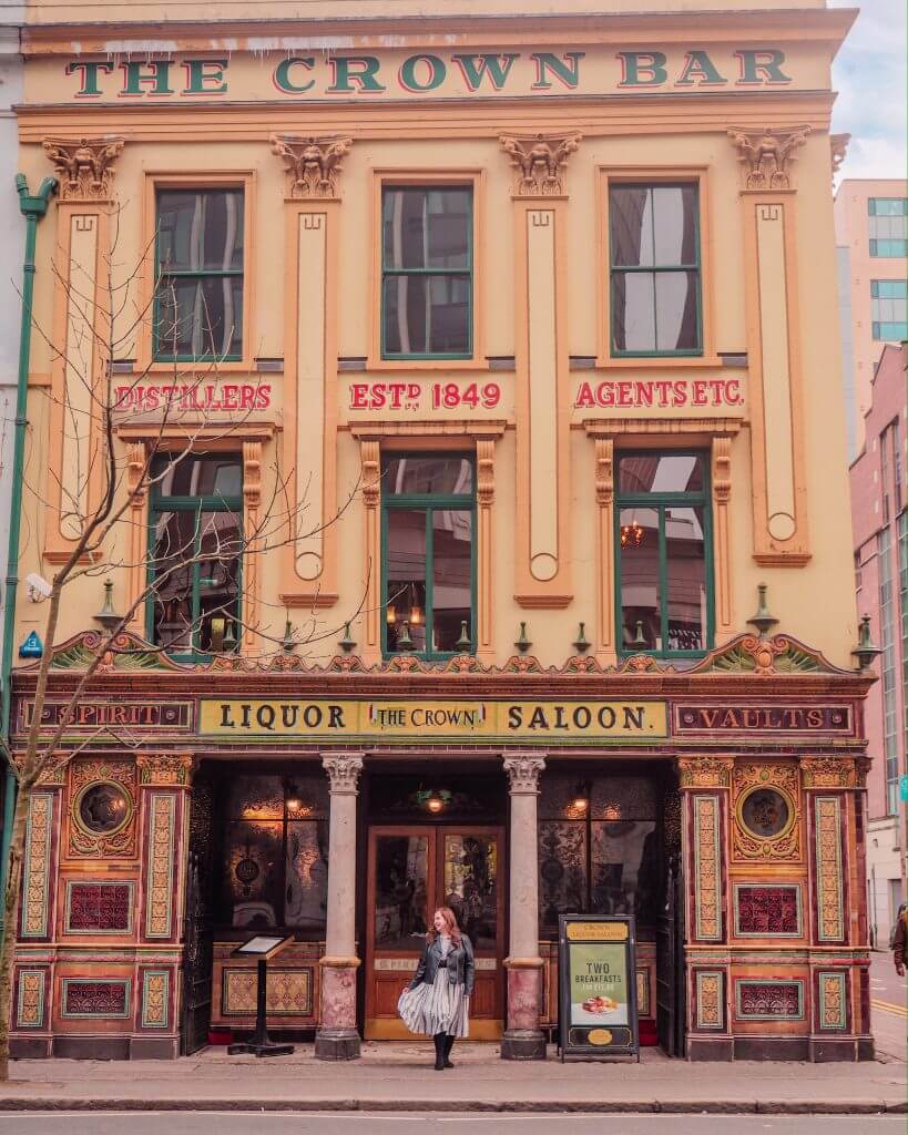 Woman standing in front of the Crown Bar in Belfast