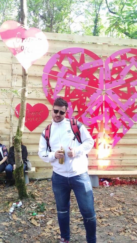 Man drinking a can of beer at a music festival