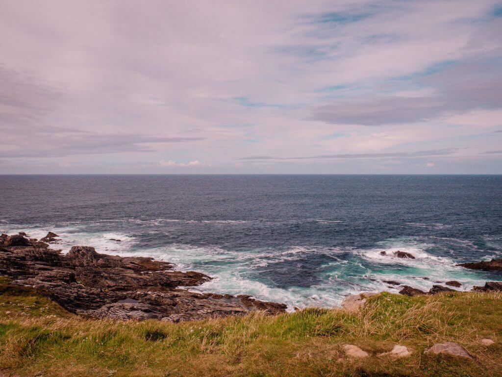 Waves crashing against the rocks at Malin Head in County Donegal Ireland