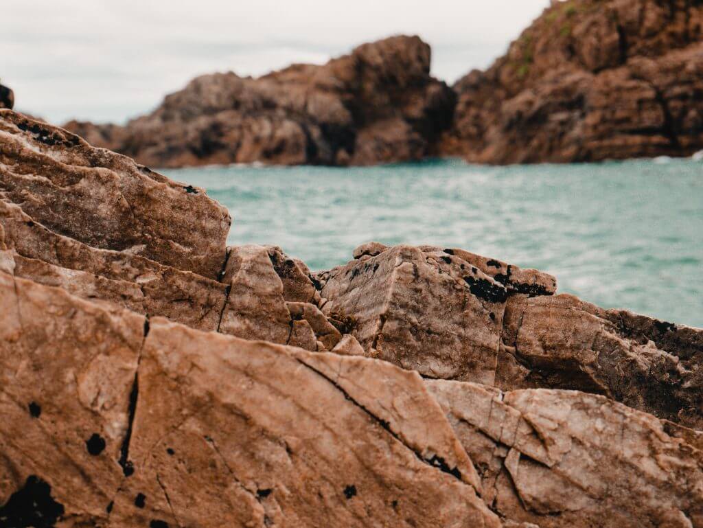 Clear blue waters and rocks at the beach of Murder Hole Beach in Northeast Donegal in Ireland