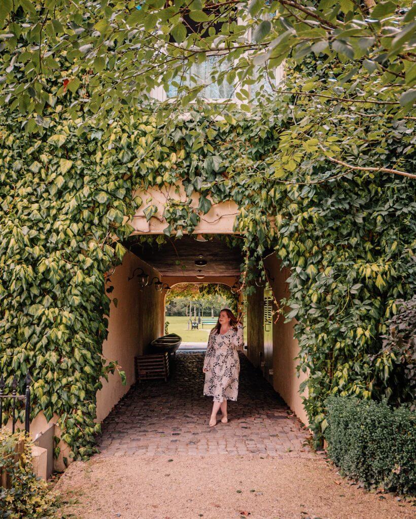 Woman standing in the doorway of Brooklodge and Macreddin Village in Wicklow Ireland