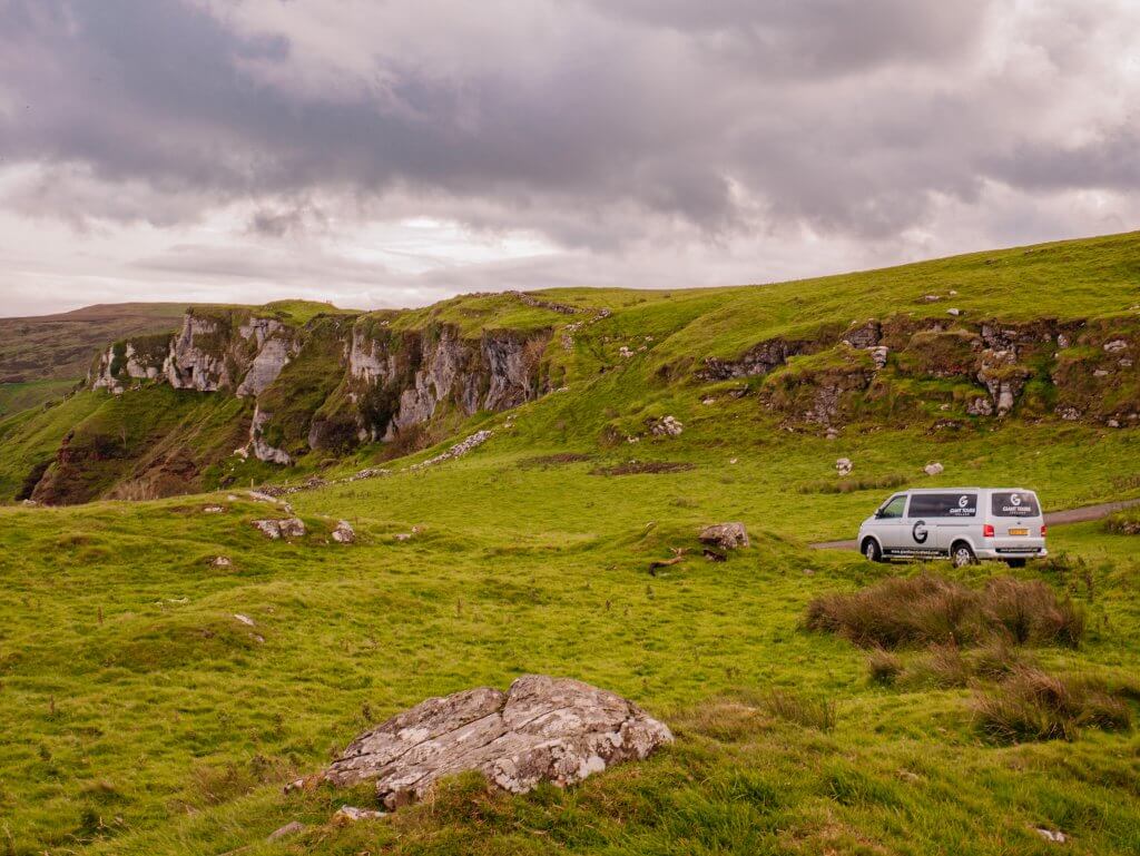 Giant Tours game of thrones van parked up against the dramatic cliffs at Murlough Bay