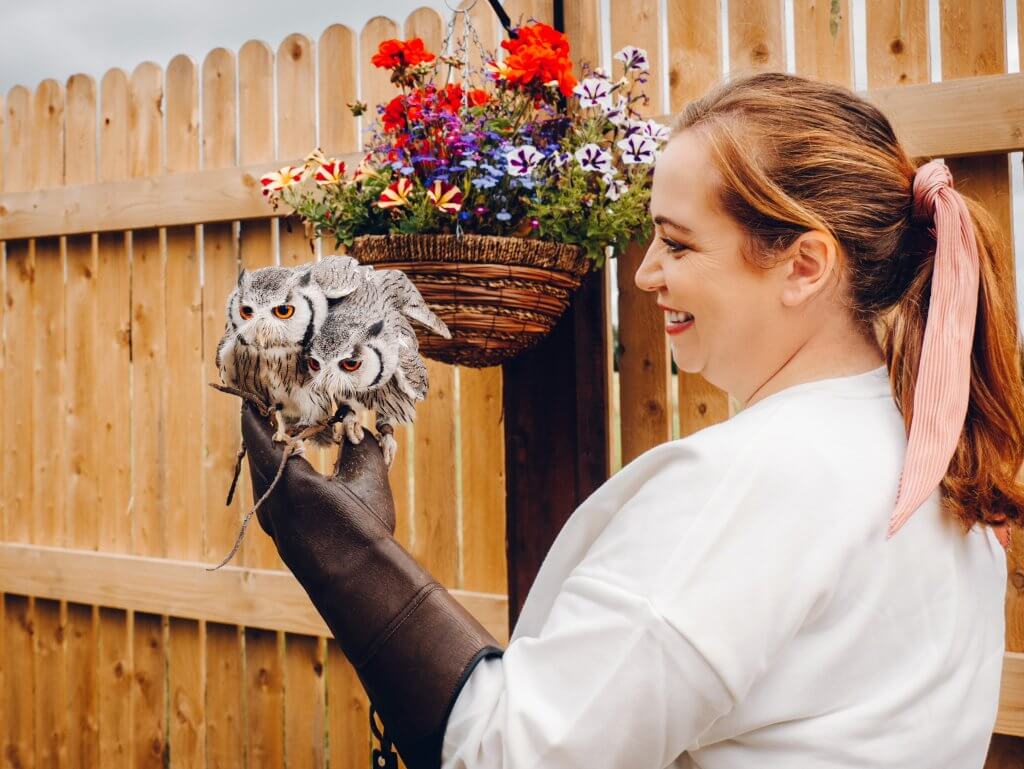 Woman getting an owl selfie with Turbo and Diesel two South African white faced owls at the hawkeye school of falconry