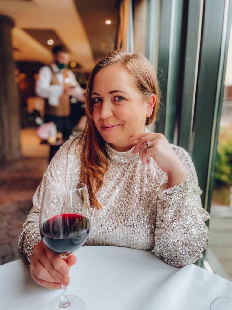 Woman in a sequin dress drinking red wine at the Lyrath Estate and Spa in Kilkenny Ireland