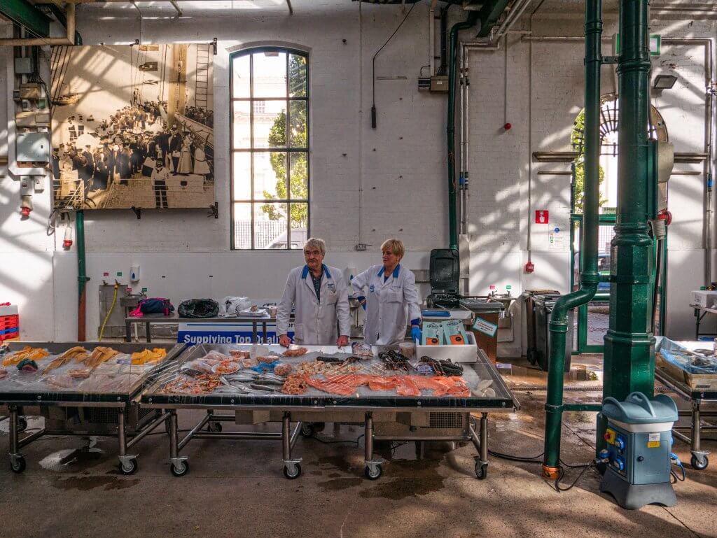 Stall selling fresh fish in St George's Market on walking tours Belfast