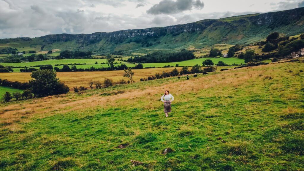 Woman standing at Sallagh Braes and Cairncastle a hidden gem in Antrim Northern Ireland