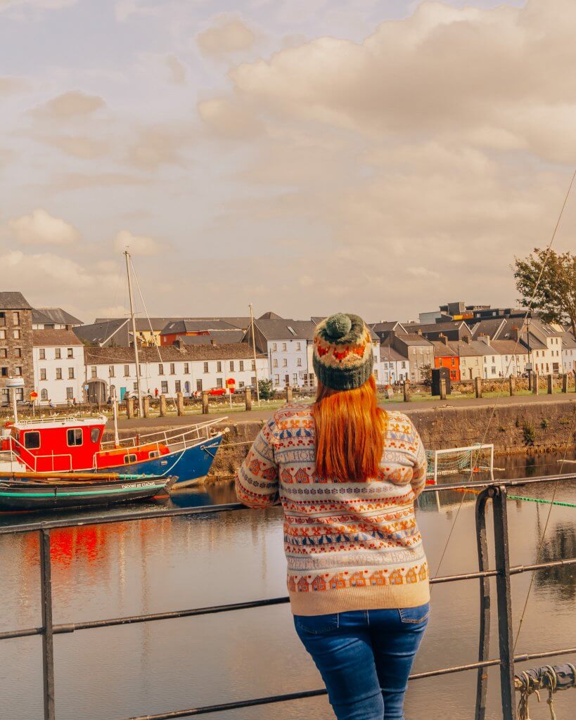Woman looking out at Galway Bay on The Long Walk Galway