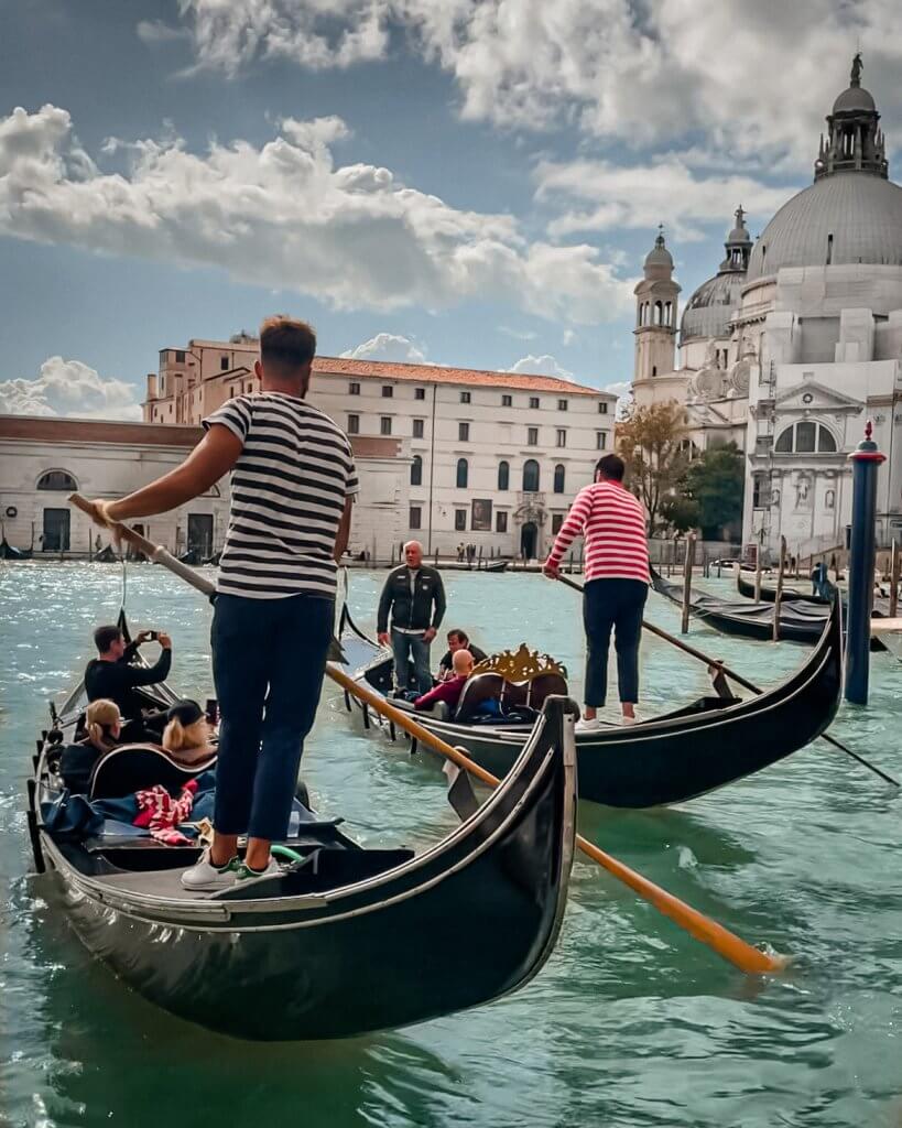 Two gondolas sailing down the Grand Canal in Venice