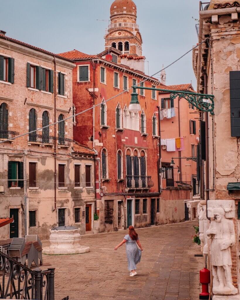 Woman twirling in the square of Campo dei Mori in the Cannaregio region of Venice Italy