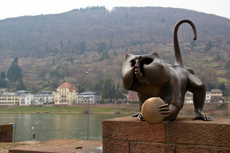 The famous BrΓΌckenaffe (Bridge Monkey) statue at the entrance to the Old Bridge in Heidelberg.