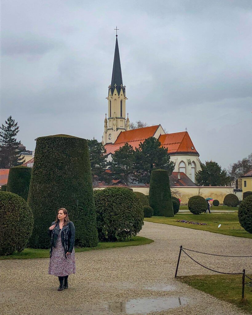 Woman walking in the rain in the gardens of Schonbrunn Palace