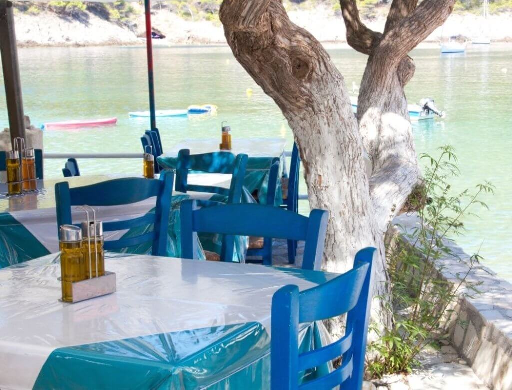 Blue chairs at a restaurant in Assos Kefalonia