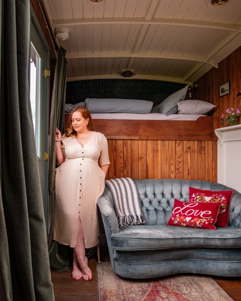 Woman wearing a cream dress in The Oat Box a cool Airbnb in Northern Ireland.