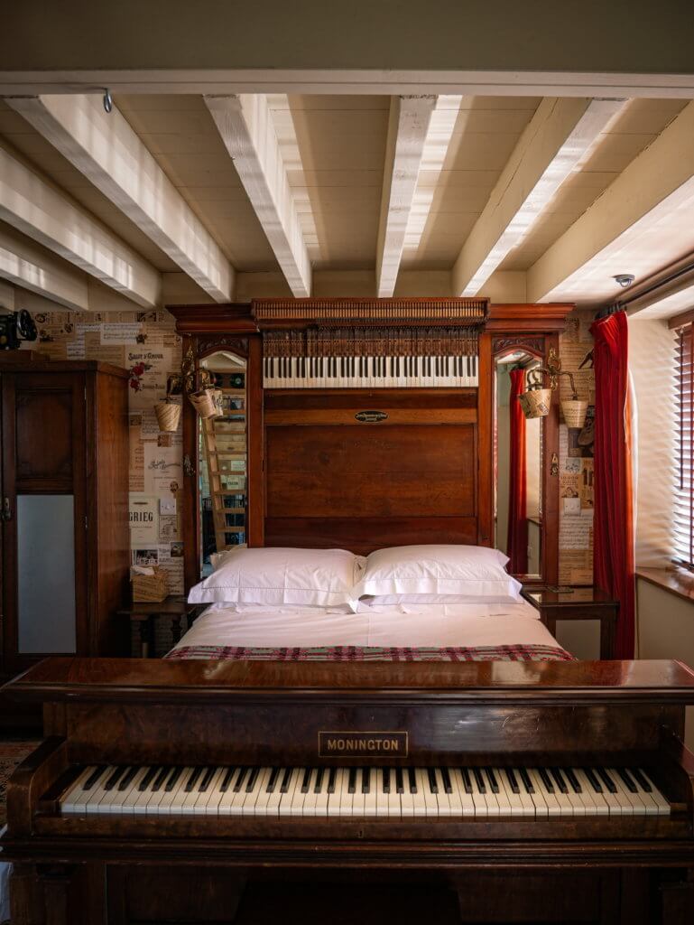 A bed made out of a piano in unique accommodation in Wales
