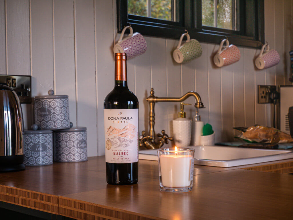 A bottle of red wine and a scented candle