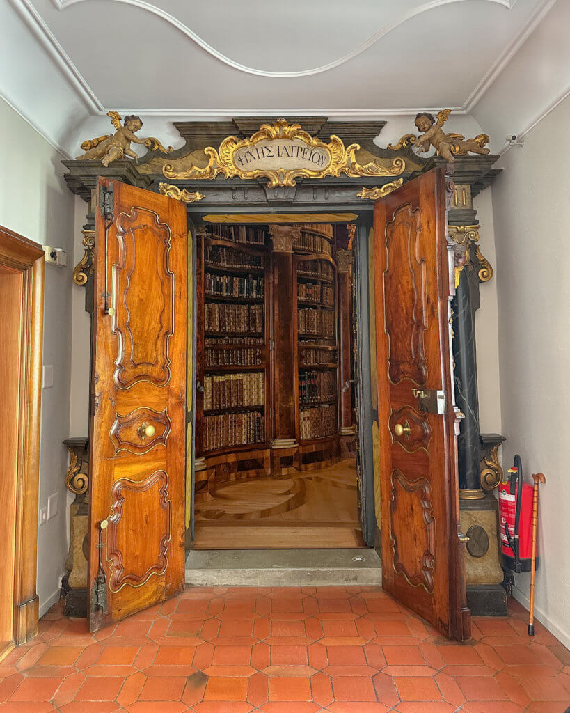 Entrance to the Abbey Library in St. Gallen. Inscription above its entrance reads ΨYXHΣ IATPEION, meaning ‘healing place for the soul’ one of the best things to do in St. Gallen.