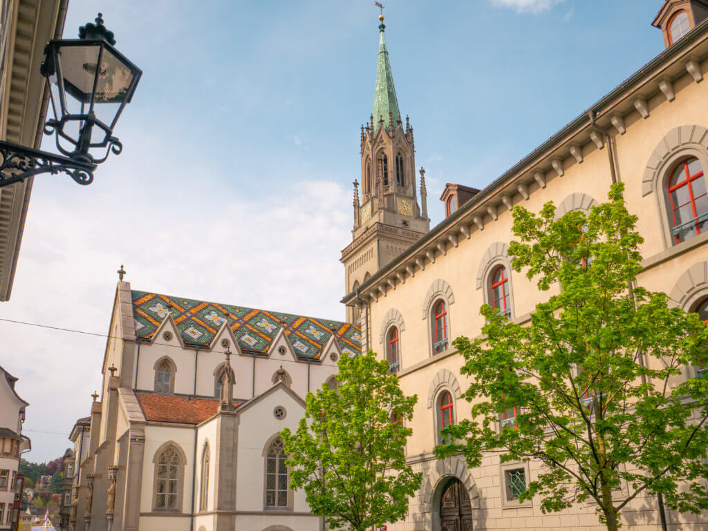 St Lawrence Church with its colourful mosaic tile roof. It is a top tourist attraction in St. Gallen Switzerland.