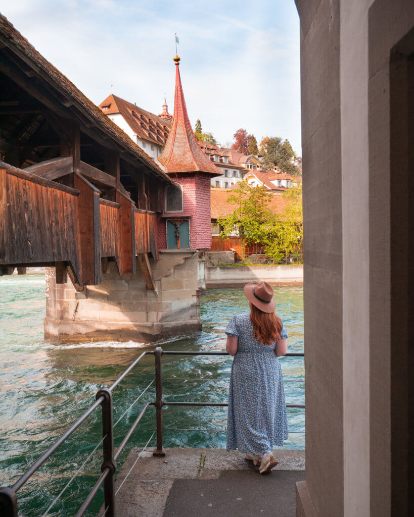 Nicola Lavin, Travel Blogger with Our Unique Stays, looks at the wooden Spreuer Bridge in Lucerne Switzerland during 24 hours in Lucerne.