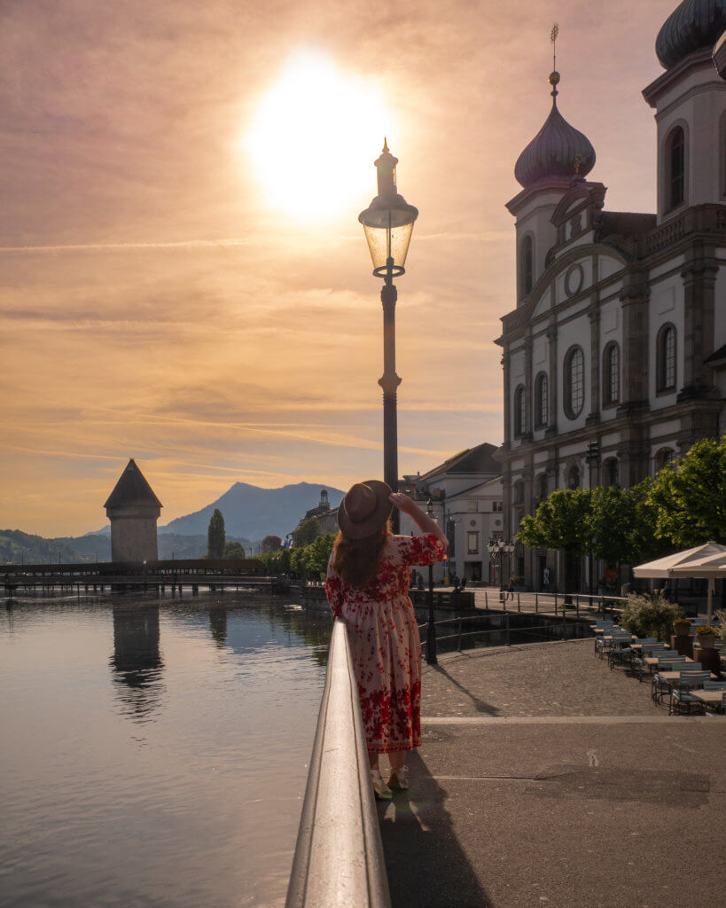Nicola Lavin, Travel Blogger with Our Unique Stays, looks at the Jesuit Church in Lucerne at sunrise.