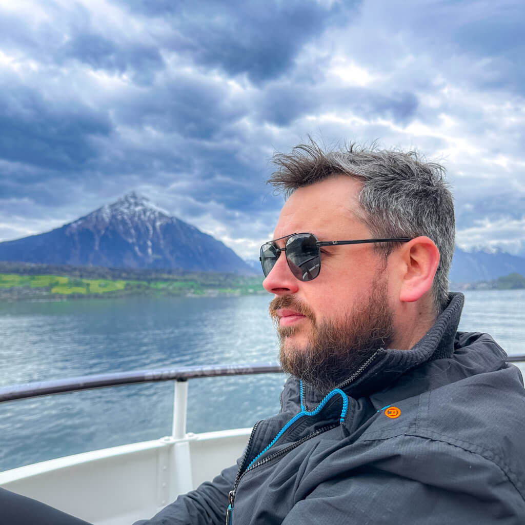 Ronan Lavin, Travel Blogger from Our Unique Stays, on a boat trip on Lake Thun using the Swiss Travel Pass