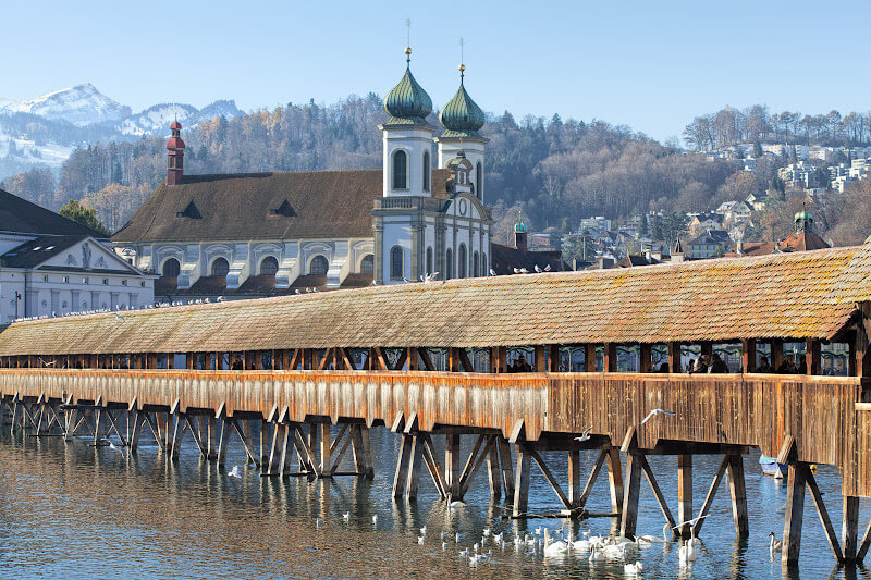 Wooden Chapel Bridge in Lucerne covered with snow in winter