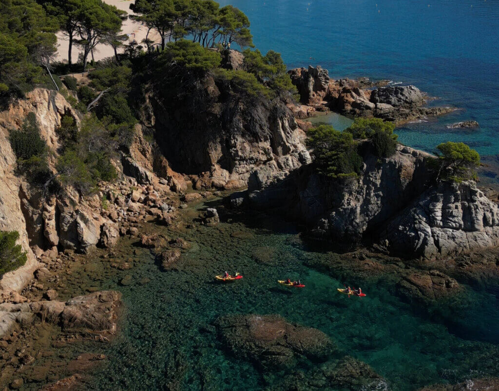 Three kayaks in turquoise blue waters in Lloret de Mar