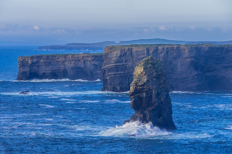 Iconic Kilkee Cliffs showcasing Ireland's wild and rugged terrain. Iconic Kilkee Cliffs showcases Ireland's wild and rugged terrain.