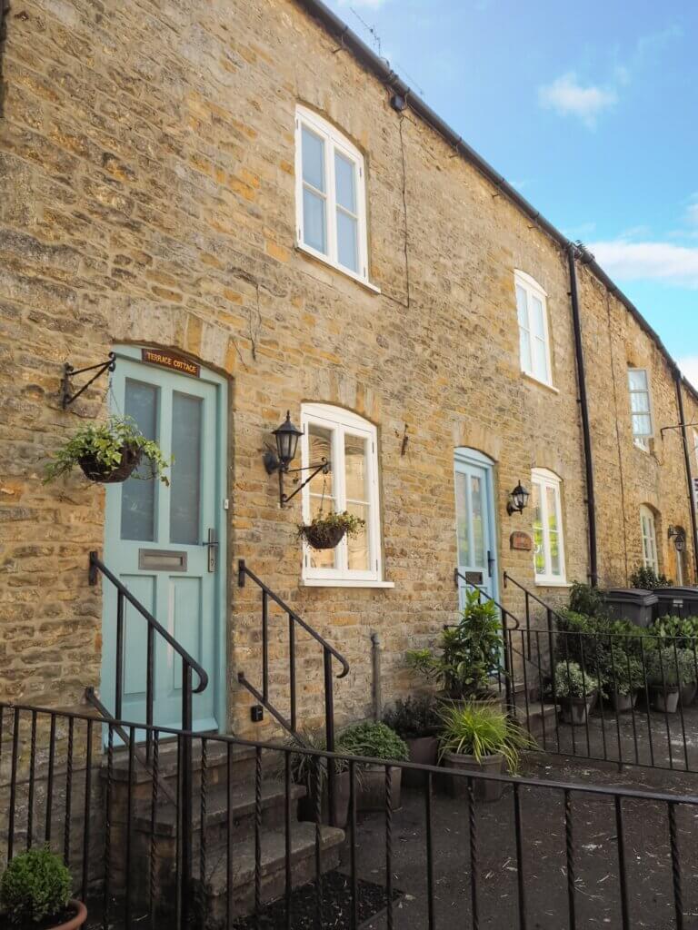 A row of charming honey-hued cottages in the pretty Cotswolds village of Stow-on-the-Wold.
