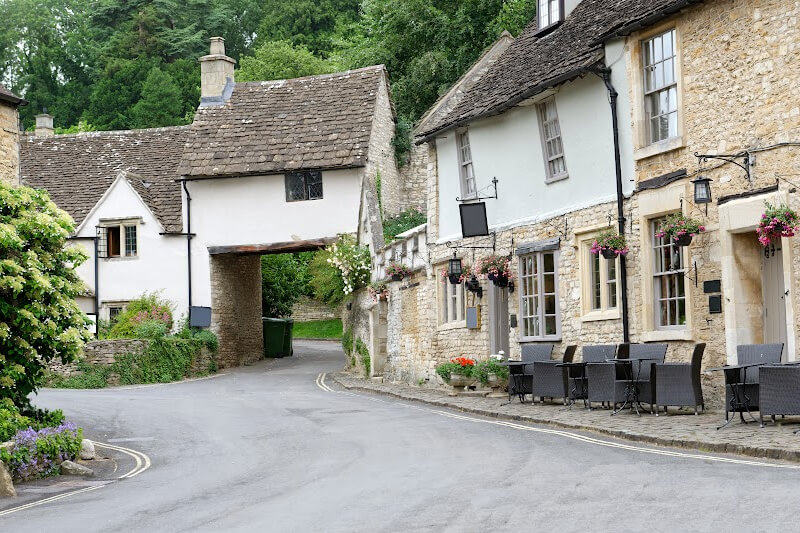 Charming village square with historic buildings in the Cotswolds.