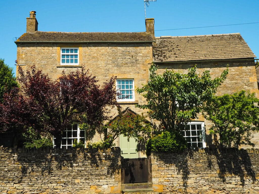 Charming fairytale cottage surrounded by trees and colourful flowers, in the pretty village of Stow-on-the-Wold in Cotswolds.