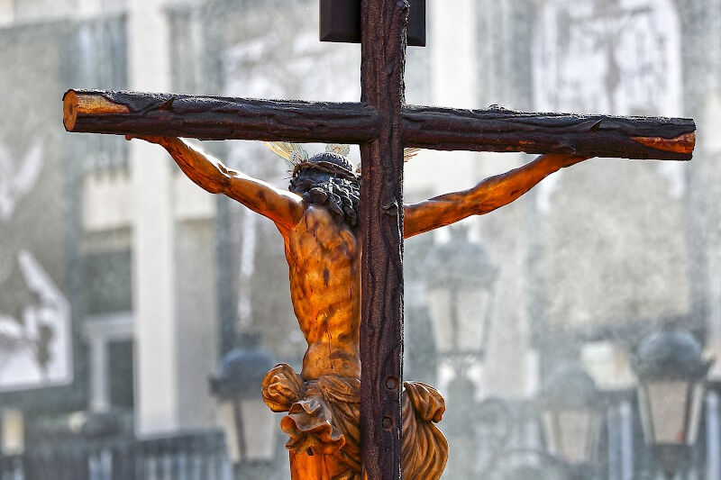 A solemn moment during Malaga's Easter parade, as participants carry religious icons through the city.