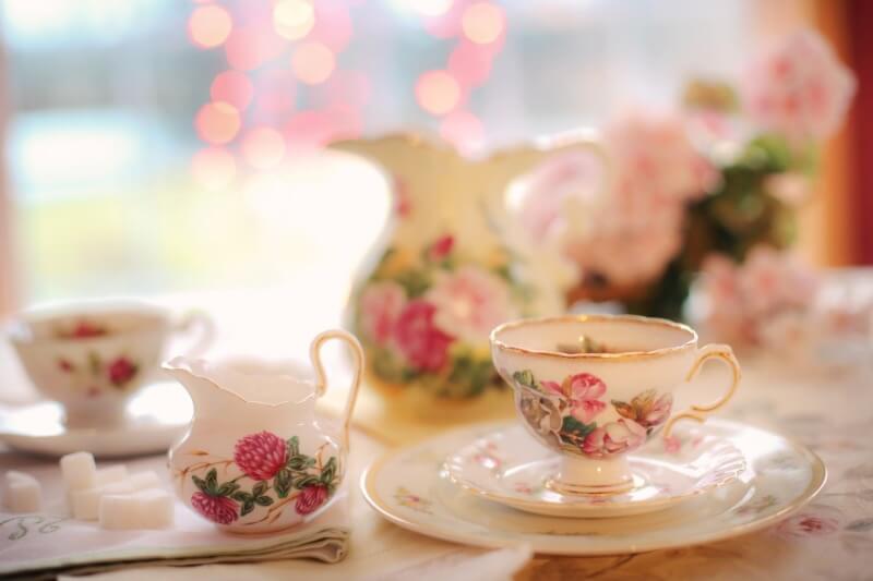 China teacups and a china milk jug set out on a table for afternoon tea in the Cotswolds.
