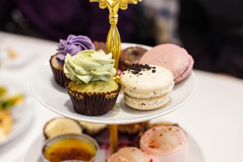 Three-tiered cakestand full of cakes and pasteries served during Afternoon Tea in the Cotswolds.