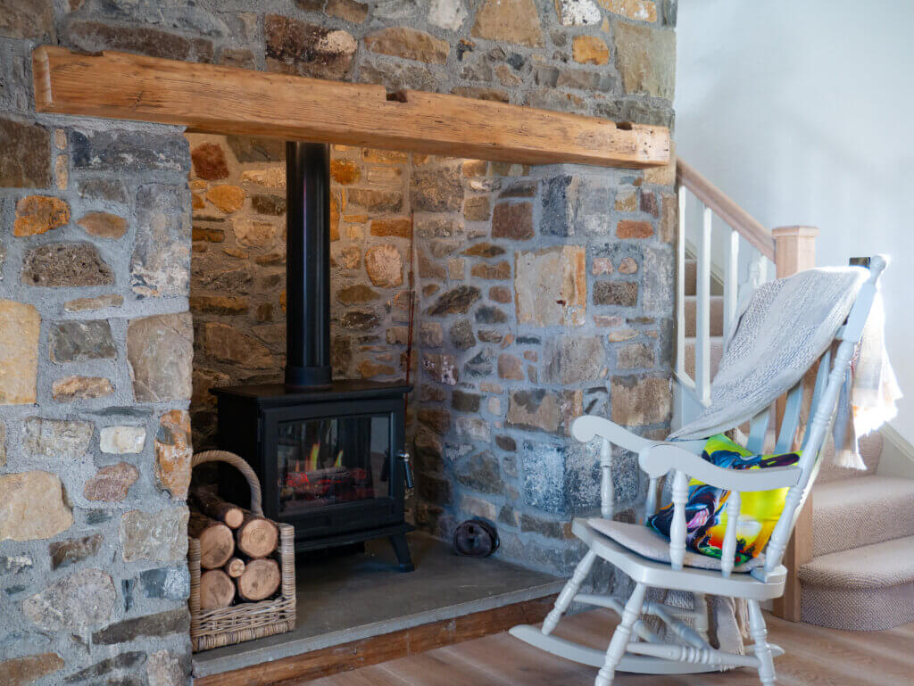 Rocking chair beside a fireplace in an Irish farmhouse in Tipperary.