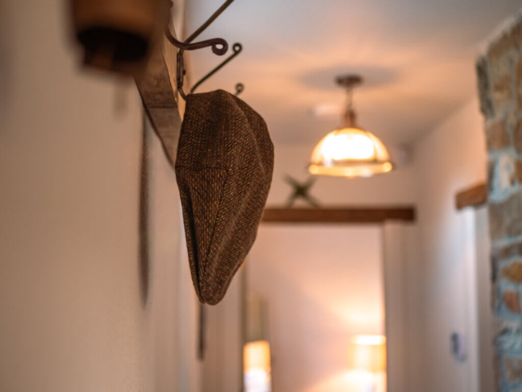 Tweed cap hung on a hook of an Irish farmhouse.