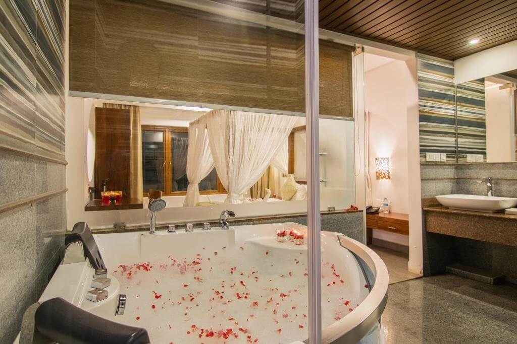 Private indoor jacuzzi in a luxury suite at a Munnar 5-star hotel.