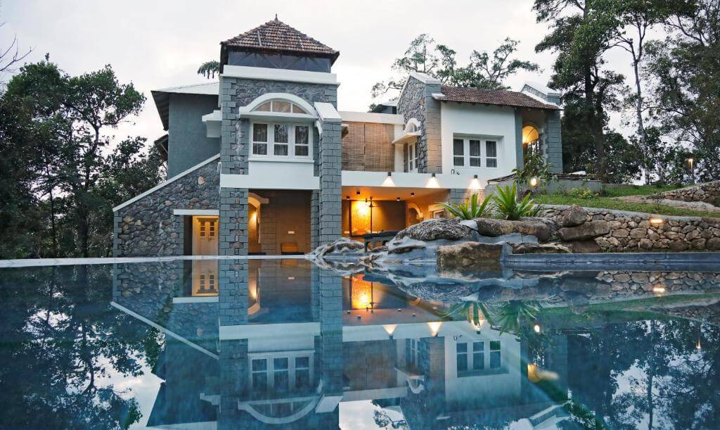 Outdoor pool with stunning views at a luxury resort in Munnar.