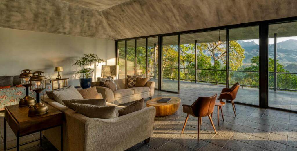Luxurious seating area of Elakai luxury villa surrounded by Munnar’s greenery.
