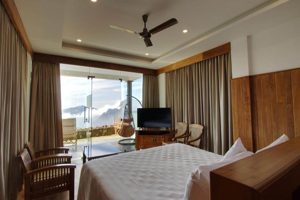 Stunning bedroom with mountain views in Chandy’s Drizzle Drops in Munnar.
