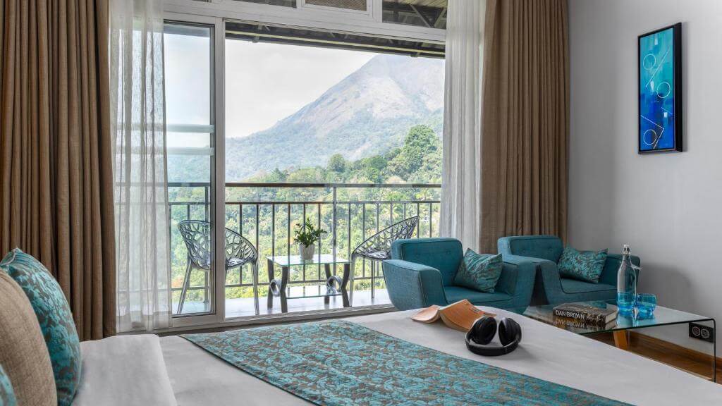 Elegant bedroom with mountain views at a top 5-star hotel in Munnar.