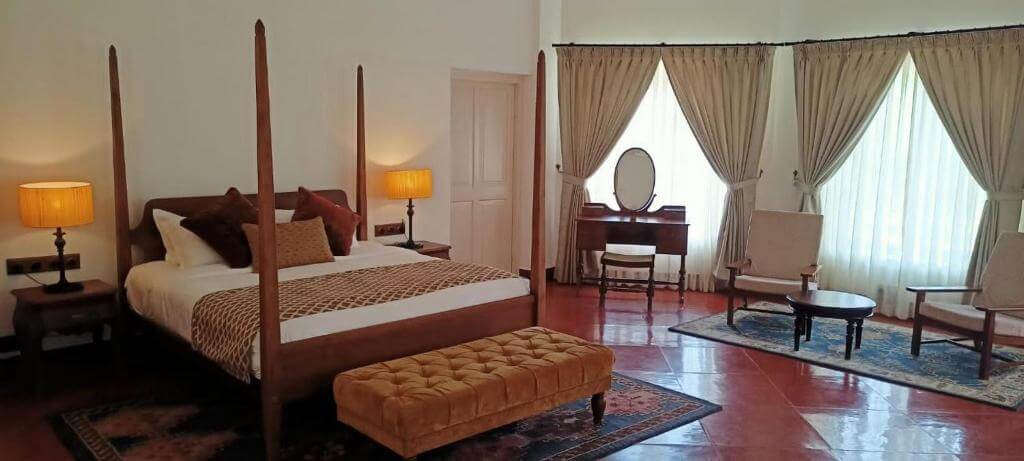 Sophisticated bedroom with a four-post bed at a luxury villa in Munnar.
